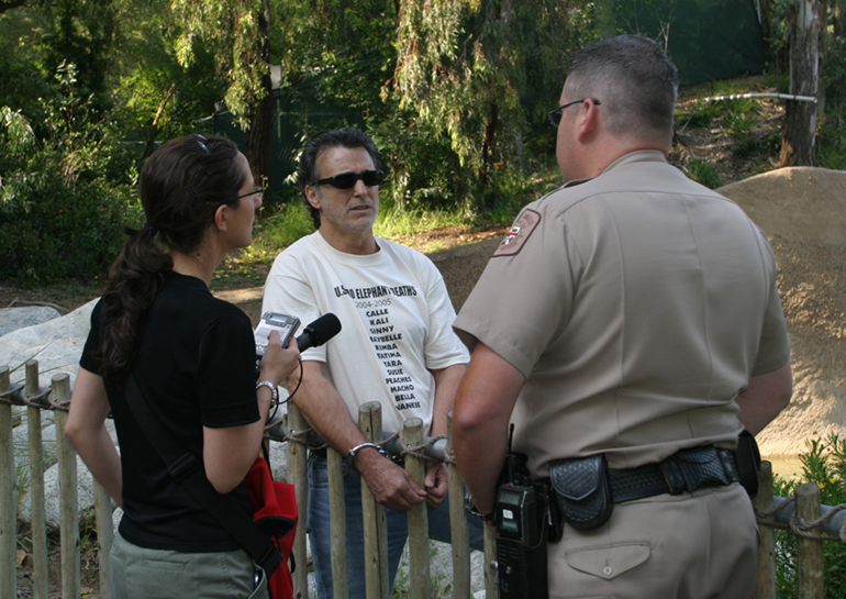 Chris DeRose handcuffed to the elephant exhibit at the LA Zoo in 2005